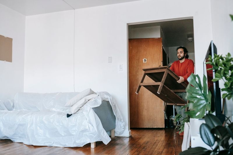 Junk removal professional carefully carrying furniture during a Fort Lauderdale, FL cleanout