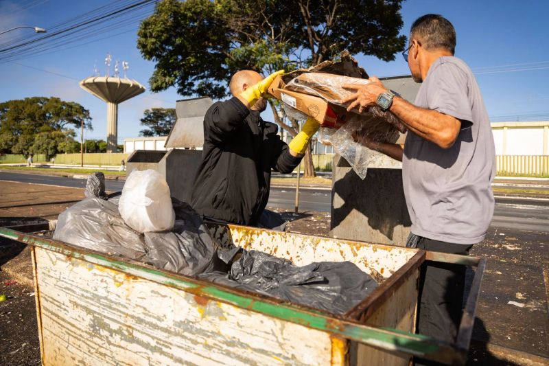 Residential junk removal professionals carrying unwanted boxes from a living room