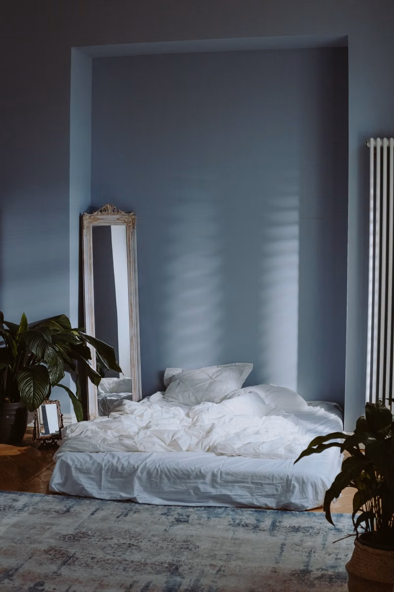 Old mattress being removed from a bedroom by a Besure Junk Removal team member