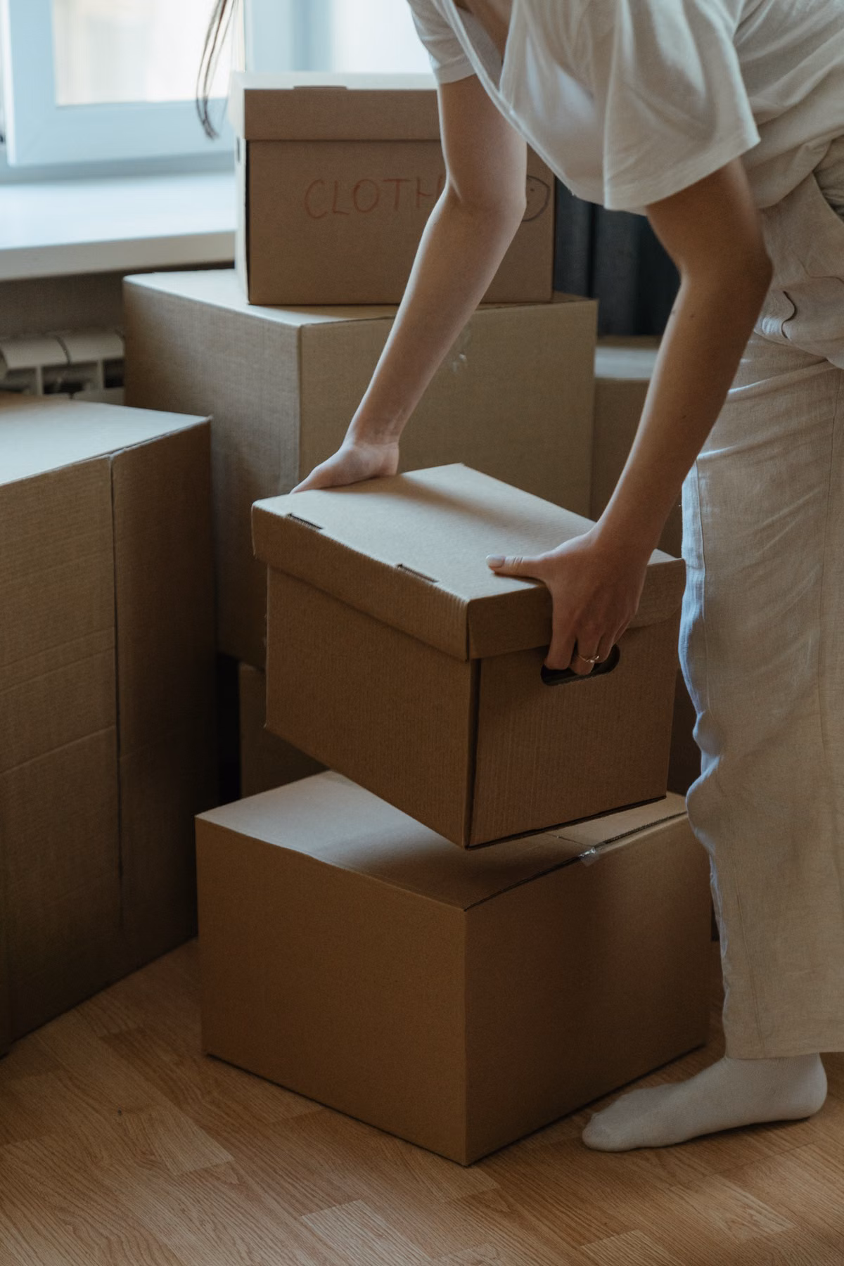Besure Junk Removal team clearing boxes and unwanted items from a Fort Lauderdale storage unit